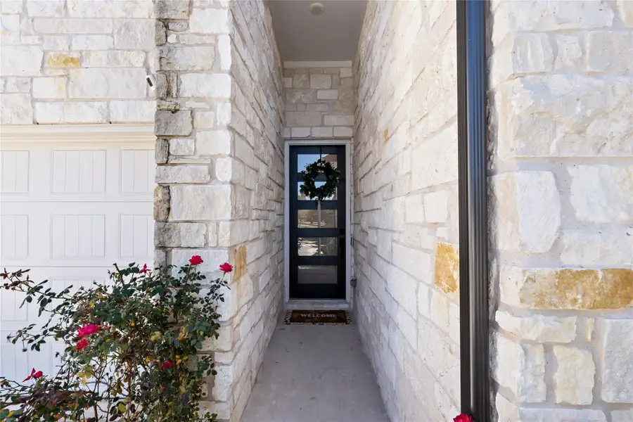 View of exterior entry with stone siding