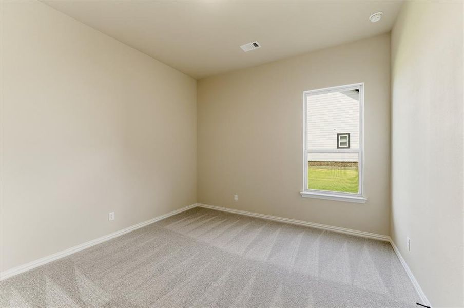 Spare room featuring light colored carpet and baseboards Spare room featuring light colored carpet and baseboards