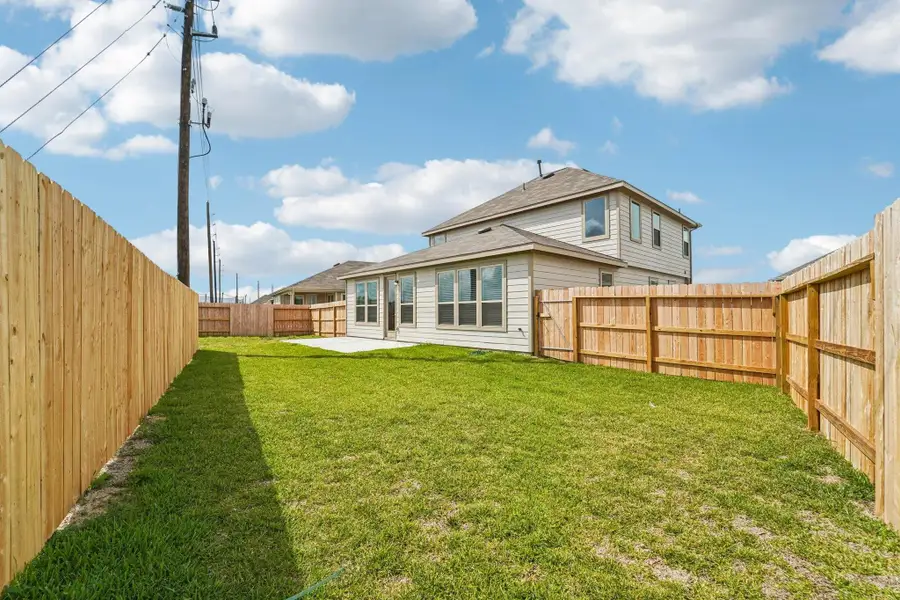 Views of the backyard green space and fully fenced yard.