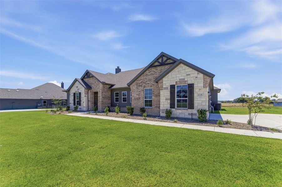 Crafted stone and brick facade featuring decorative gables and dark window shutters