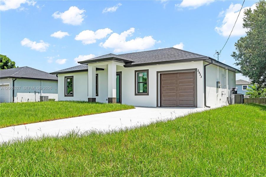 Front exterior of a new home in , Lehigh Acres, FL, highlighting curb appeal (Image 2). Front exterior of a new home in , Lehigh Acres, FL, highlighting curb appeal (Image 2).