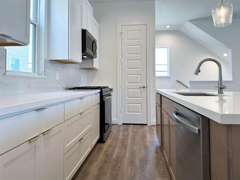 2nd Floor - Kitchen with standard Samsung appliances.*Photos of previous model with similar floor plan.  Finishes will be based on spec for Erin Park community.*