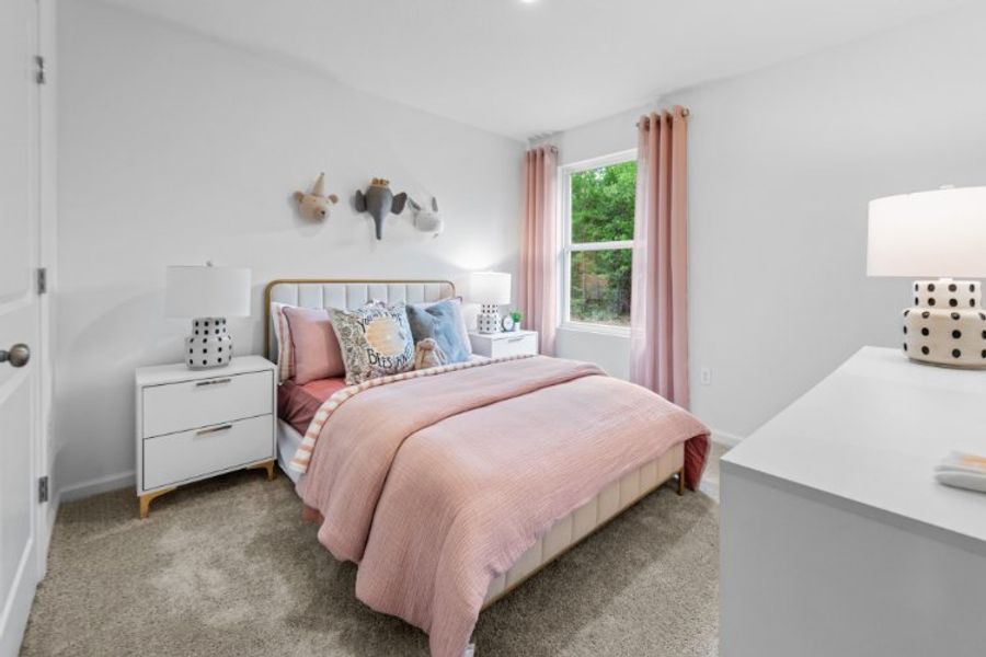 A bedroom with a pink bed. A bedroom with a pink bed.