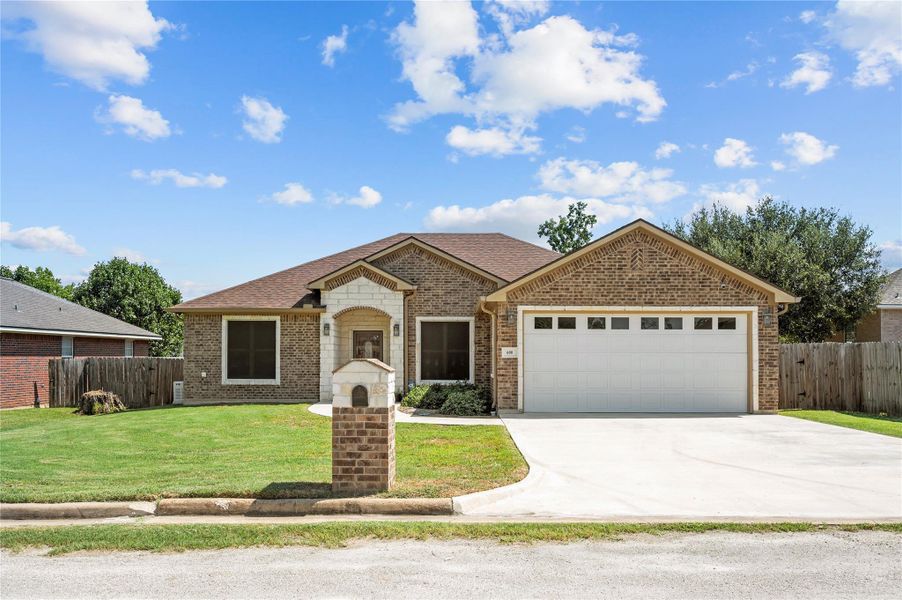 Front exterior of a new home in , Madisonville, TX, highlighting curb appeal (Image 19).