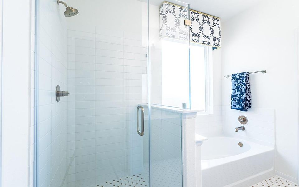 Full bathroom with a stall shower and a garden tub Full bathroom with a stall shower and a garden tub