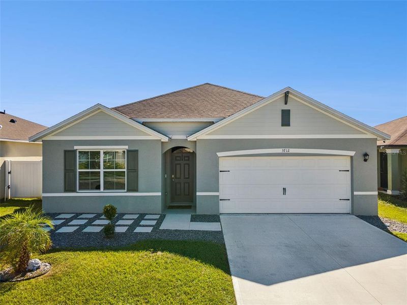 Front exterior of a new home in Wind Meadows South, Bartow, FL, highlighting curb appeal (Image 2).