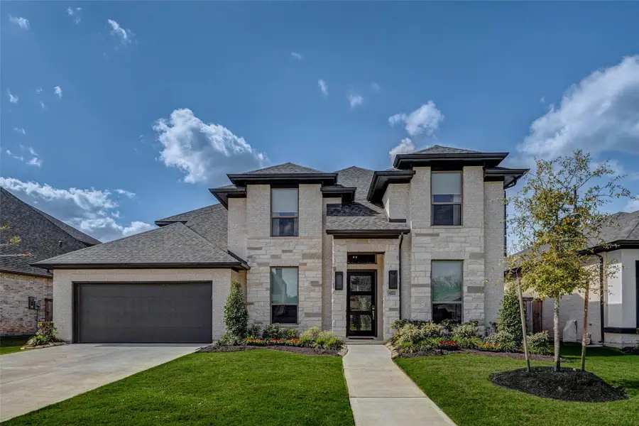 This modern two-story home features a brick facade, large windows, and a double-car garage. It's surrounded by a well-maintained lawn with landscaped plants along the walkway, offering great curb appeal. This modern two-story home features a brick facade, large windows, and a double-car garage. It's surrounded by a well-maintained lawn with landscaped plants along the walkway, offering great curb appeal.