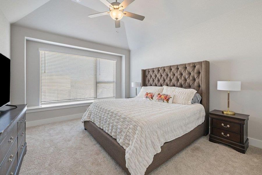 Spacious primary retreat with custom build-in seating area and room to unwind.