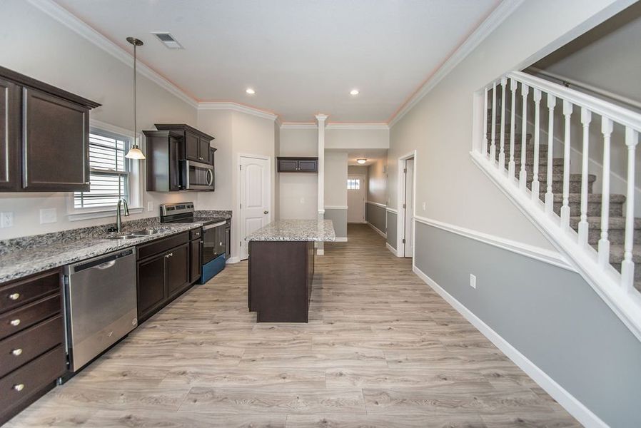 Representative furnished interior of a home built from the Quincy by Enchanted Homes in Hampshire Heights, Moore (Image 11).