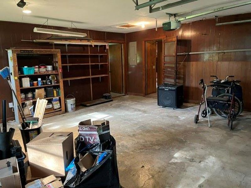Garage interior featuring wood paneling Garage interior featuring wood paneling