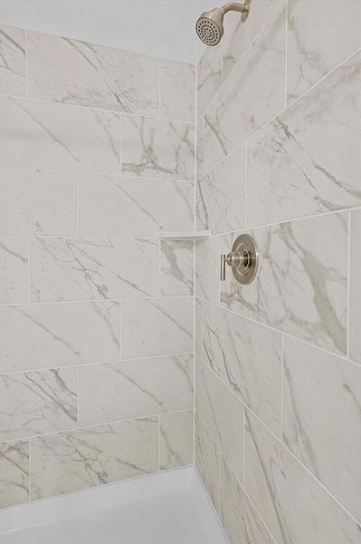 Full bathroom featuring a tile shower