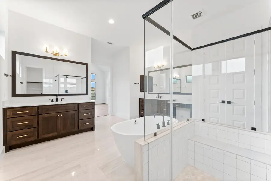 Separate Sinks, Linen Closet, and Walk-in Shower with Bench.