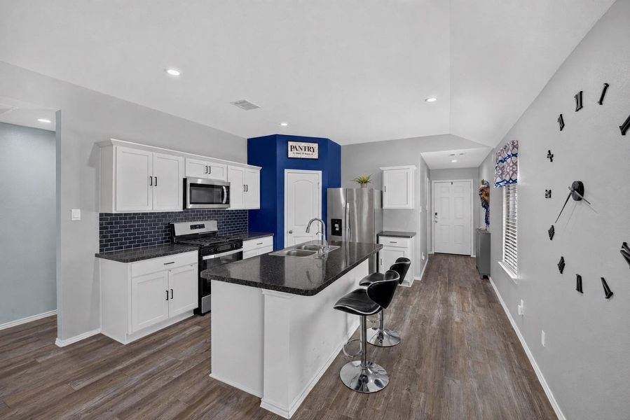 Spacious kitchen island provides additional prep space and casual seating while maintaining an open connection to the living area. Spacious kitchen island provides additional prep space and casual seating while maintaining an open connection to the living area.