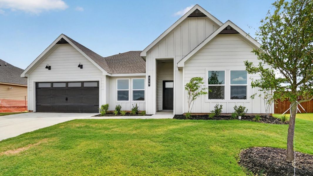 Front exterior of a new home in Sandstone Estates, Granbury, TX, highlighting curb appeal (Image 2). Front exterior of a new home in Sandstone Estates, Granbury, TX, highlighting curb appeal (Image 2).
