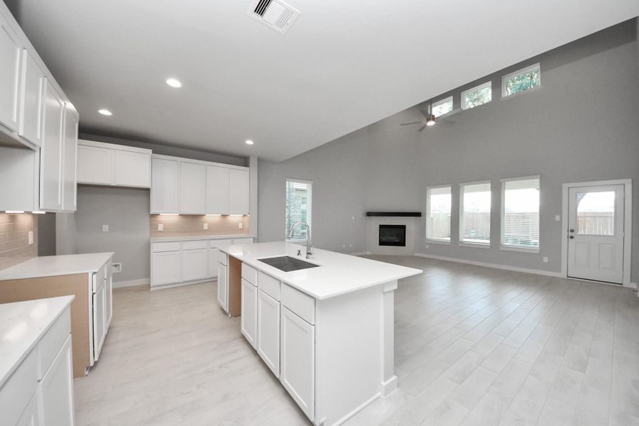 This kitchen is by far any chef’s dream! This spacious kitchen features high ceilings, light stained wood cabinets, granite countertop, SS appliances, modern tile backsplash, recessed lighting, extended counter space, granite kitchen island with double sink, and space for breakfast bar, and a walk-in pantry all overlooking your huge family room. Sample photo of completed home with similar floor plan. Actual colors and selections may vary.