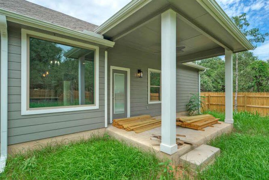 View of exterior entry with roof with shingles