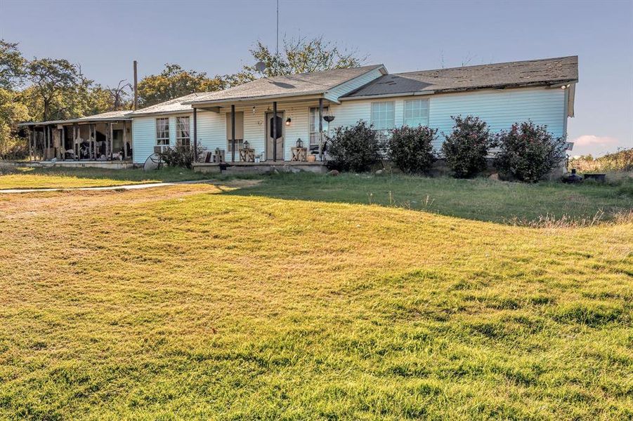 Ranch-style house with a front lawn and covered porch Ranch-style house with a front lawn and covered porch