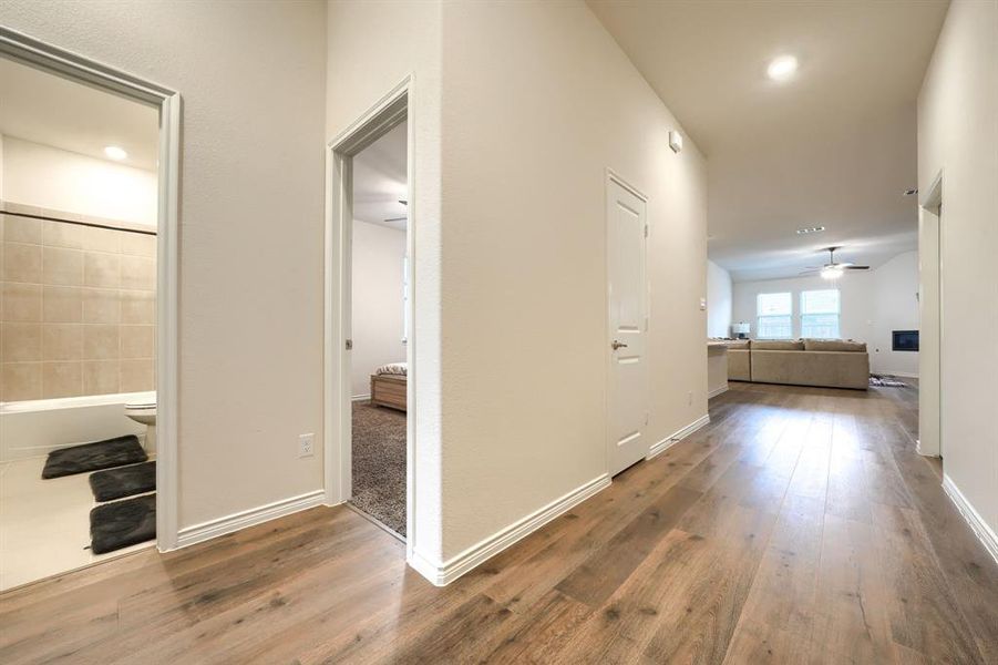 Corridor with hardwood / wood-style flooring and recessed lighting Corridor with hardwood / wood-style flooring and recessed lighting