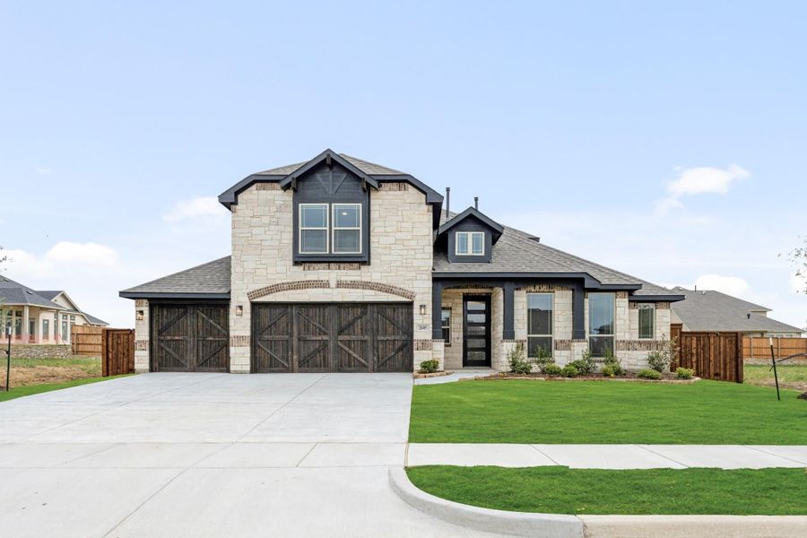 Two-story home with stone exterior, three-car garage with wood doors, and manicured front lawn Two-story home with stone exterior, three-car garage with wood doors, and manicured front lawn