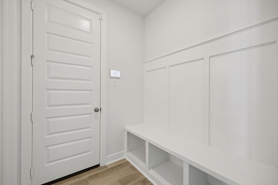 This practical mudroom offers built-in storage, providing a convenient and organized space for shoes, coats, and everyday essentials.