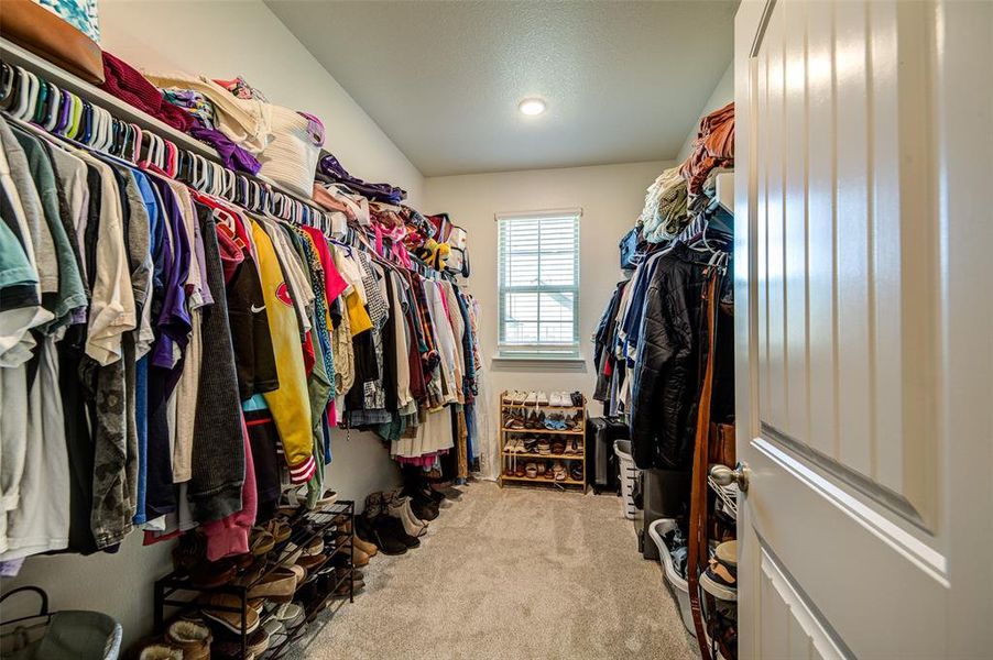 Walk in closet featuring light carpet