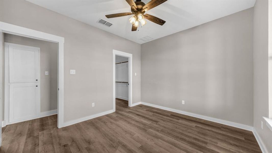 Bedroom featuring ceiling fan and a walk in closet