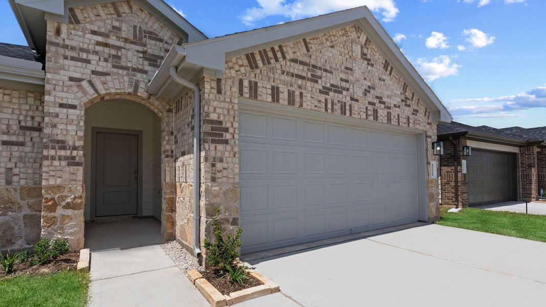 Front exterior of a new home in Tamarron, Fulshear, TX, highlighting curb appeal (Image 2). Front exterior of a new home in Tamarron, Fulshear, TX, highlighting curb appeal (Image 2).