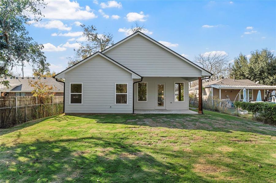 Rear view of property featuring a fenced backyard and a patio Rear view of property featuring a fenced backyard and a patio
