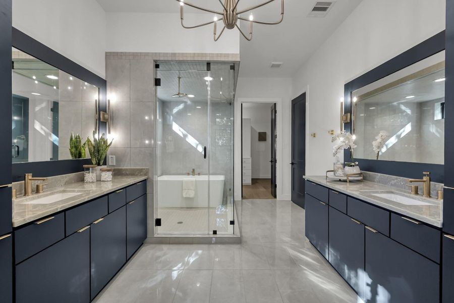 Primary bath with dual vanities, soaking tub, and glass-enclosed shower. Primary bath with dual vanities, soaking tub, and glass-enclosed shower.