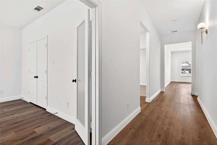Hallway featuring dark wood-type flooring