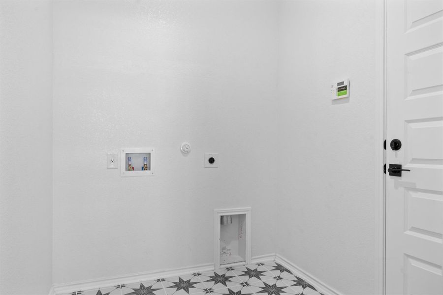 Laundry area with gas dryer hookup, hookup for a washing machine, and electric dryer hookup