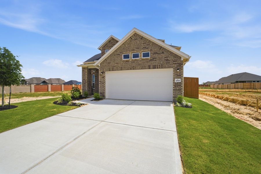 Front exterior of a new home in Wildrye, Waller, TX, highlighting curb appeal (Image 27).