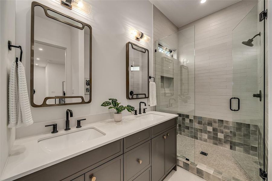 Full bath featuring a shower stall, double vanity, and recessed lighting Full bath featuring a shower stall, double vanity, and recessed lighting