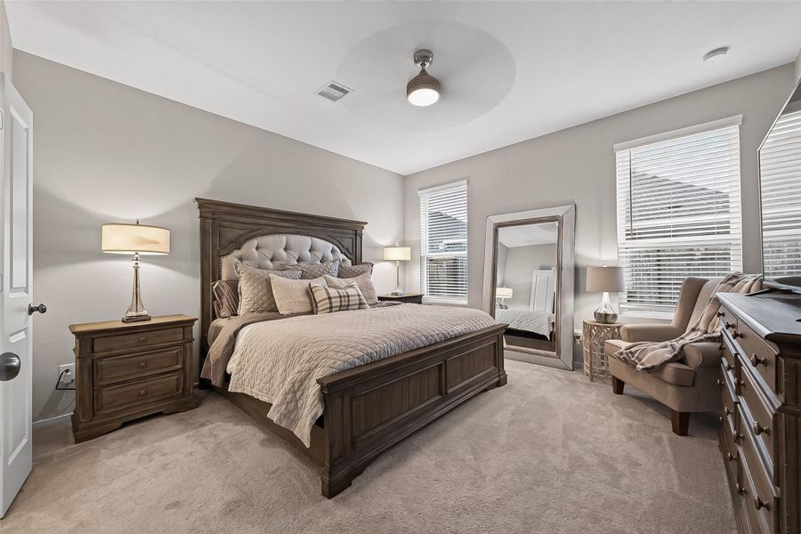 Spacious primary bedroom with abundant natural light and room for a sitting area. Spacious primary bedroom with abundant natural light and room for a sitting area.
