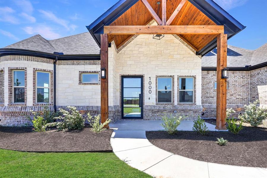 Stone and brick facade with a prominent wood-beamed entry