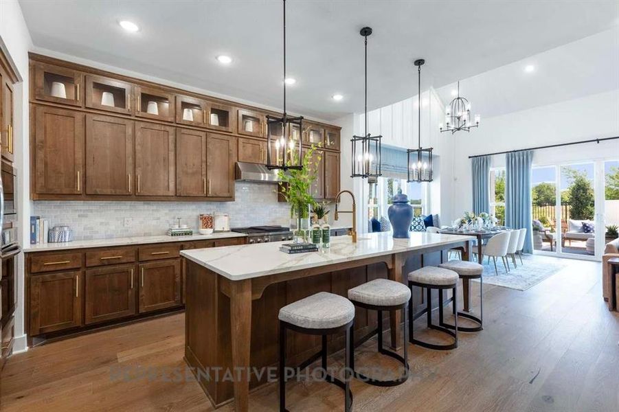 Kitchen featuring a kitchen bar, tasteful backsplash, dark wood-style floors, a kitchen island with sink, and recessed lighting