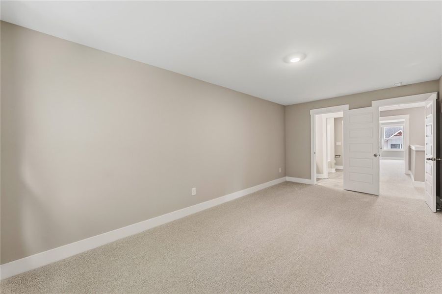 A spacious room offers comfortable carpeting, rece