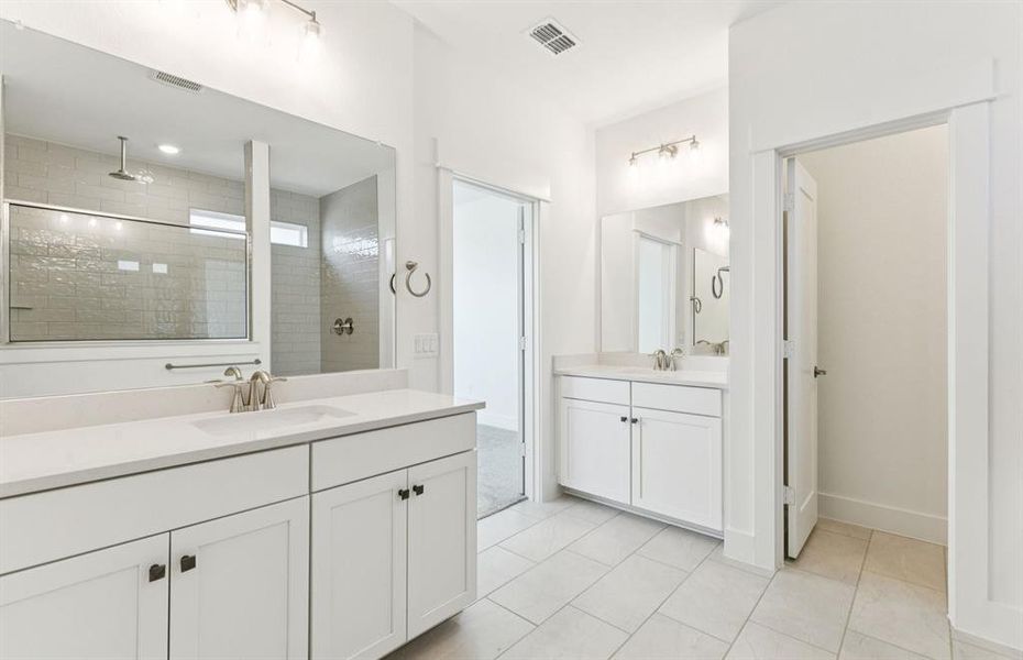 Modern owner's bath with dual vanities