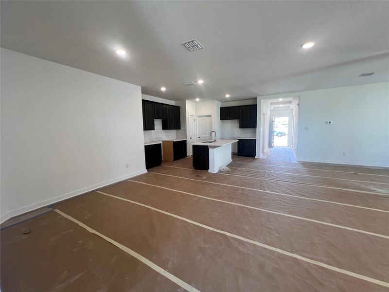 Unfurnished living room featuring baseboards and recessed lighting Unfurnished living room featuring baseboards and recessed lighting