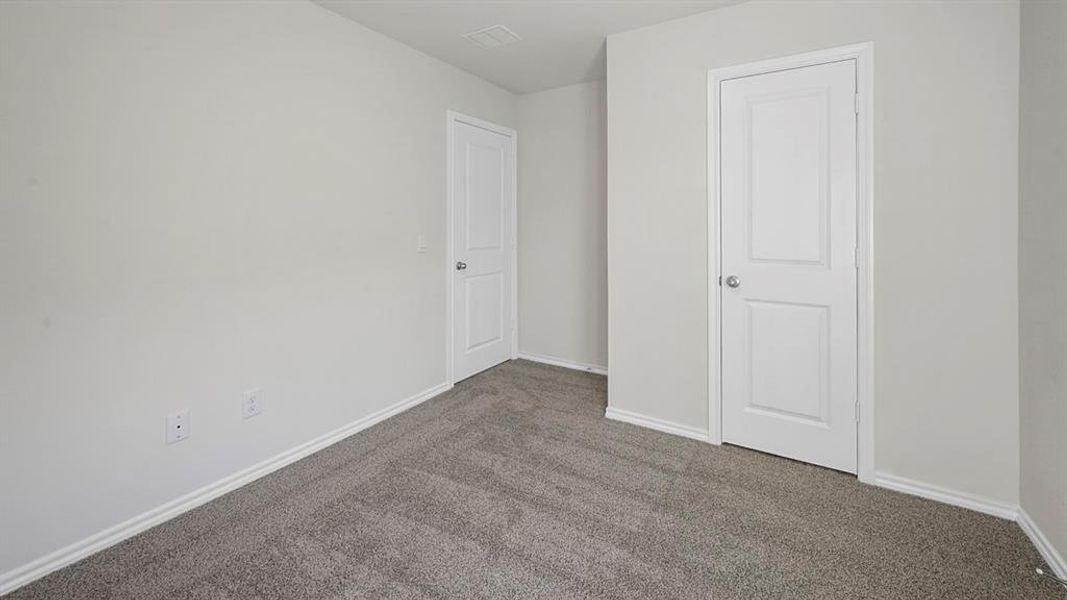 Unfurnished bedroom featuring carpet flooring and baseboards