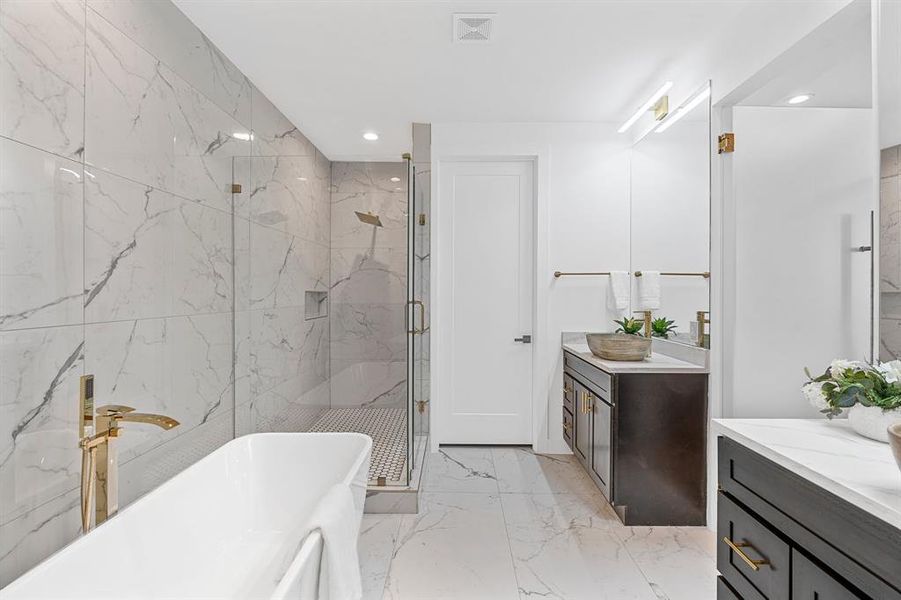 Bathroom featuring tile flooring, separate shower and tub, and vanity