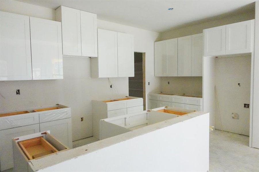 Kitchen featuring white cabinetry