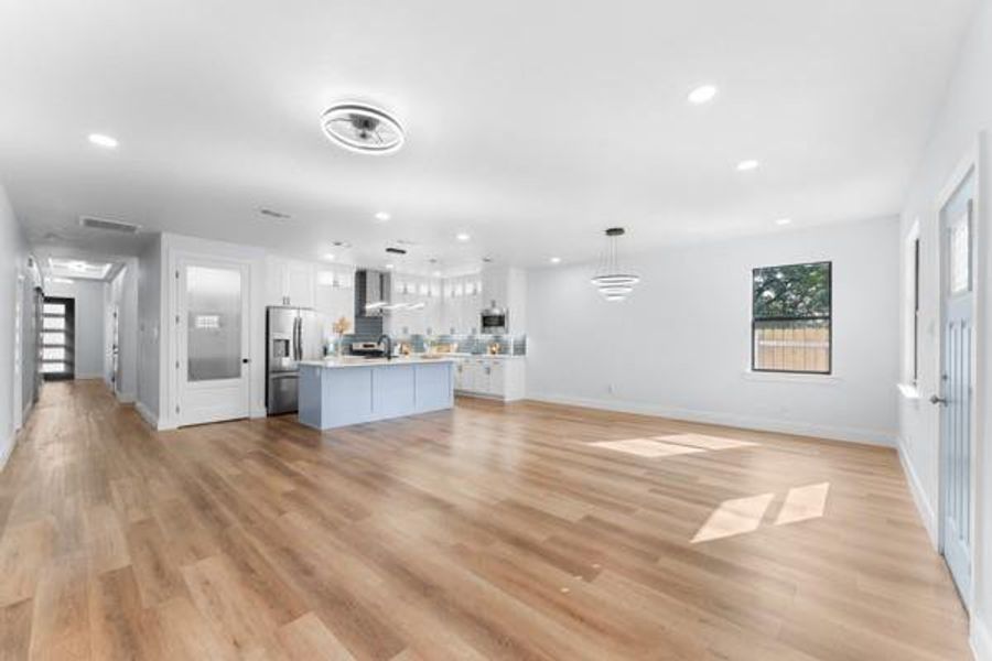 Unfurnished living room with light wood-style floors and recessed lighting Unfurnished living room with light wood-style floors and recessed lighting