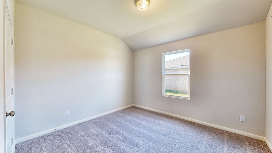 A room with a carpet and a window. A room with a carpet and a window.