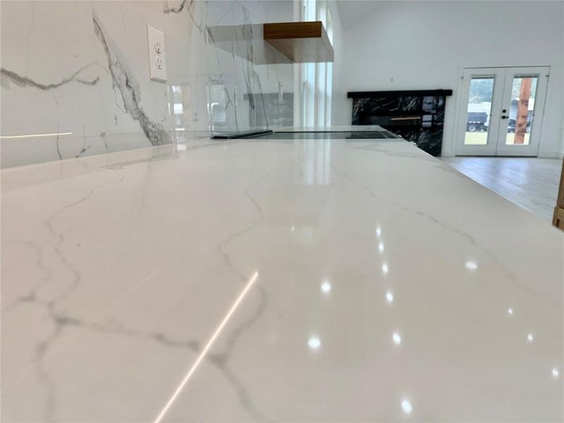 Kitchen view of light stone counters and french doors Kitchen view of light stone counters and french doors