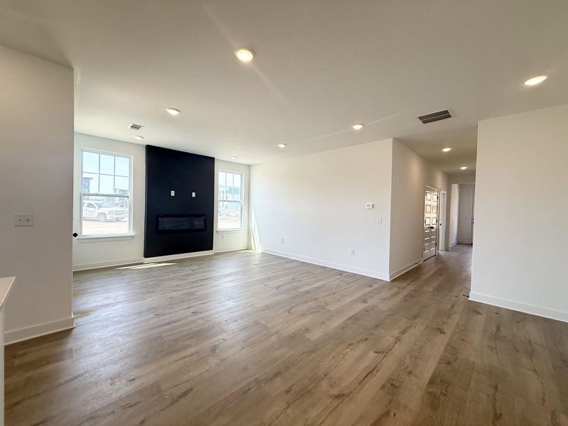 Foyer entrance featuring a large fireplace, light wood-style flooring, and recessed lighting
