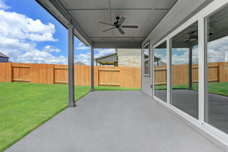 Beautiful sliding glass doors lead to back covered patio