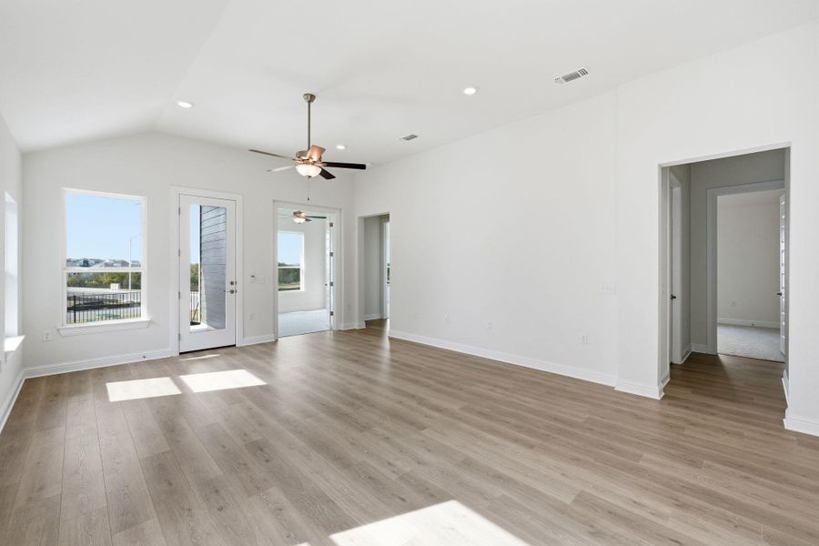 Unfurnished living room featuring recessed lighting, light wood-style floors, vaulted ceiling, and a ceiling fan Unfurnished living room featuring recessed lighting, light wood-style floors, vaulted ceiling, and a ceiling fan