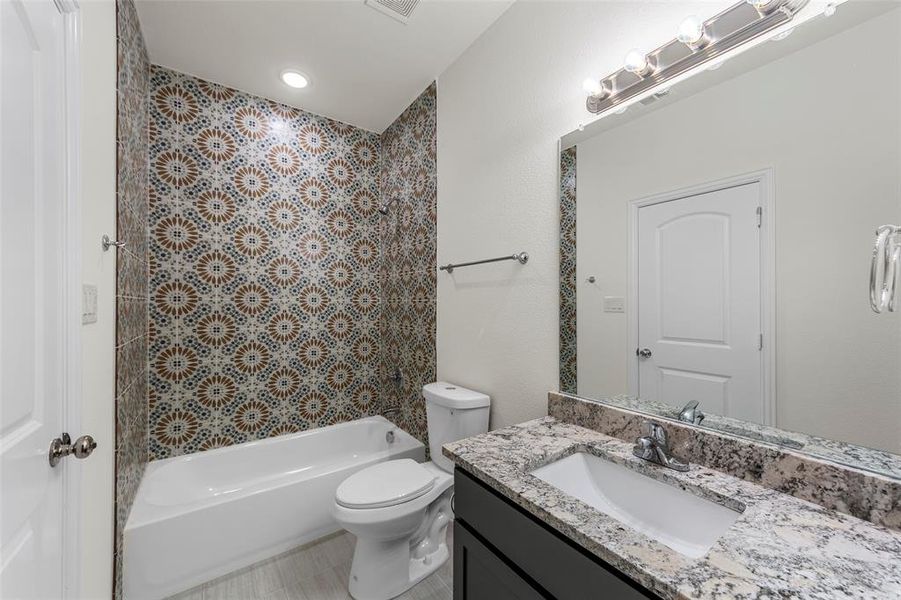 Full bathroom with vanity, toilet, and bathing tub / shower combination