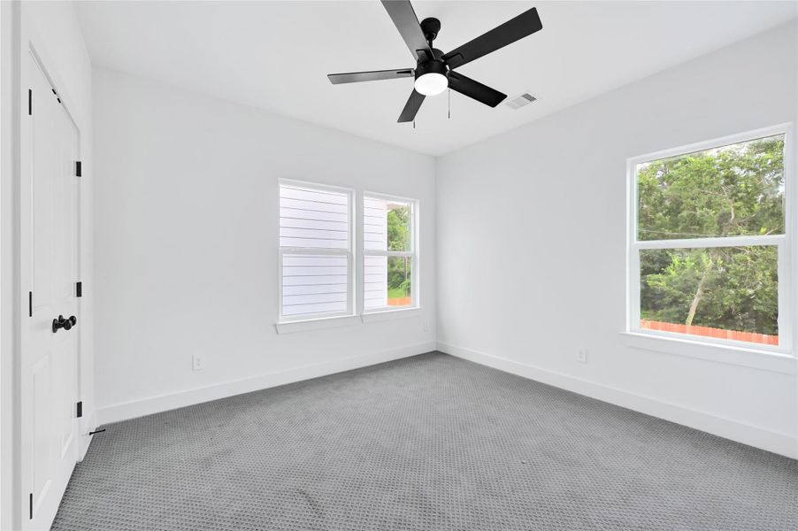 Primary suite with plush carpet and ceiling fan. Primary suite with plush carpet and ceiling fan.